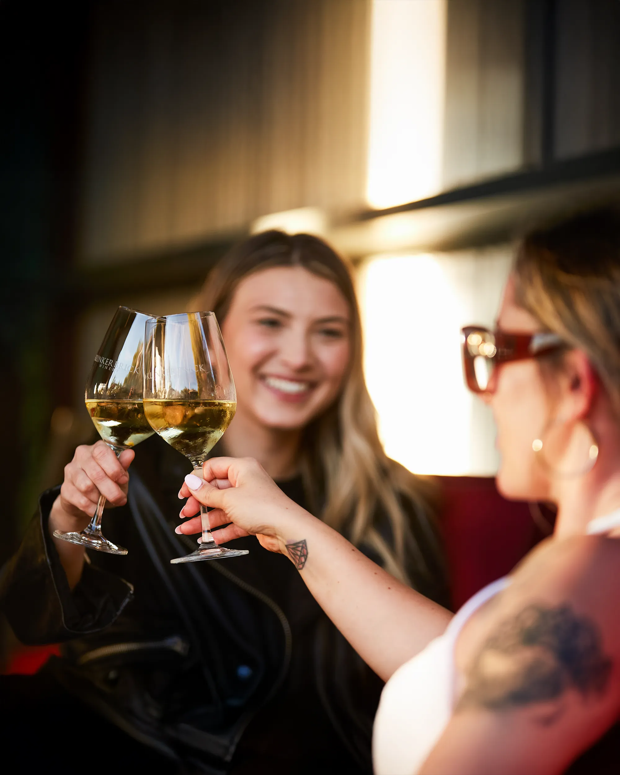 Two people toasting glasses of Klinker Brick Wine